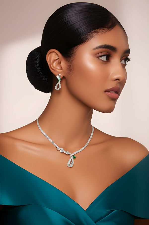 Woman wearing a diamond necklace and earrings against a neutral background